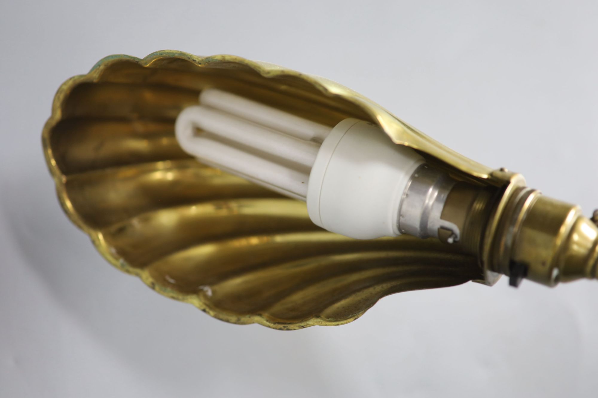 A brass anglepoise shell desk lamp